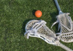Lacrosse sticks and ball on artificial turf. Great for background .